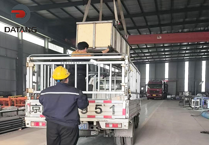 Loading heavy-duty wooden crates of laser welded finned tubes onto trucks at Datang factory