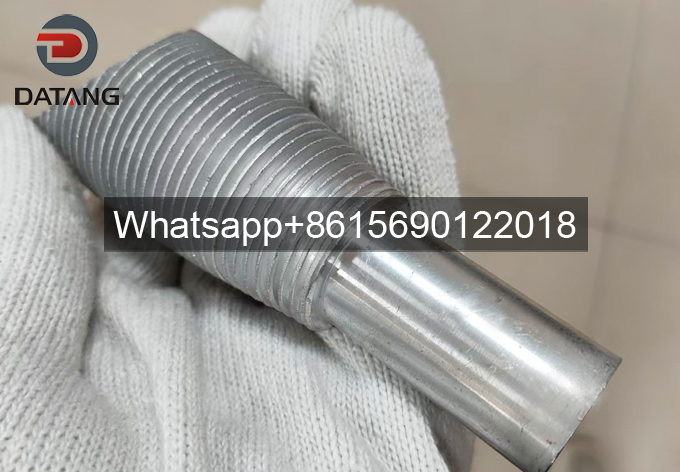 Close-up of bimetallic extruded fin tube cross-section showing 100% tight bond between stainless steel core tube and aluminum fins for zero thermal resistance