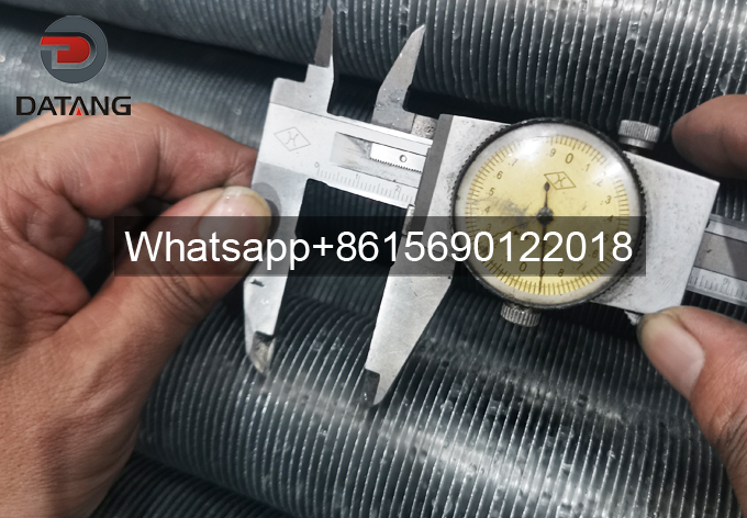 QC inspector verifying the uniform 2.3mm fin pitch of extruded fin tubes during outgoing quality control QC inspector verifying the uniform 2.3mm fin pitch of extruded fin tubes during outgoing quality control