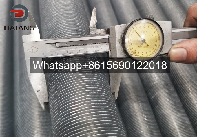 Quality technician measuring 57mm OD extruded fin tube during First Article Inspection Quality technician measuring 57mm OD extruded fin tube during First Article Inspection